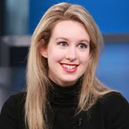 Theranos CEO Elizabeth Holmes in a black t-shirt poses for a picture.